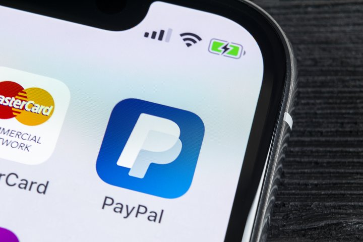 PayPal application icon on Apple iPhone X smartphone screen close-up showing new PayPal features. PayPal app icon. PayPal is an online electronic finance payment system.